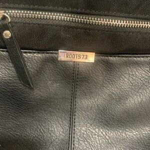 Roots cross body bag/purse black 2 good size pockets and an inner zip one